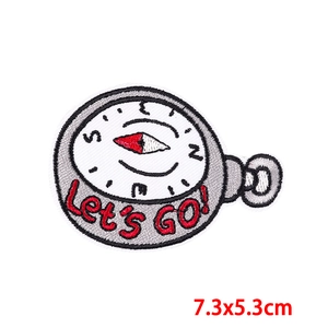 Detailed embroidery patch showing a 7.3x5.3cm compass design with Let's Go text