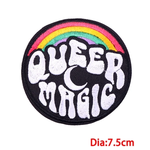 Detail of 7.5cm Queer Magic round embroidered patch with rainbow motif on black fabric