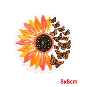 Detail of 8x8cm sunflower and butterfly embroidery patch with vivid orange thread textures
