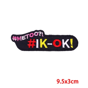 Detailed view of #METOO and #IK-OK embroidered patch with dimensions 9.5x3cm