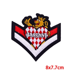 Detail of embroidered lion crest patch with red heart and Brasant text, 8x7.7cm size