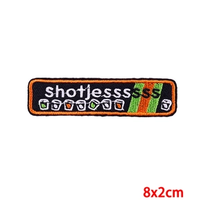 Embroidered 8x2cm carnival patch with letters and cup icons on a black base