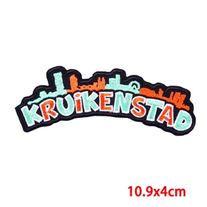 Detailed close-up of Kruikenstad skyline embroidery patch with 10.9x4cm size guide