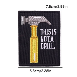 Embroidered black hammer patch with 'This Is Not A Drill' text in 7.6cm x 5.8cm size