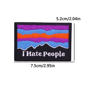 Macro view of embroidered mountain patch with I Hate People slogan and 7.5cm size mark