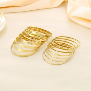 Minimalist gold plated stainless steel stackable bangle bracelets in a luxurious stackable set
