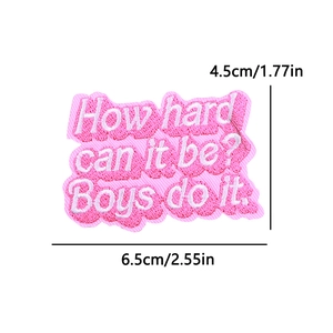 Macro detail of pink rectangular embroidery patch with white slogan and wavy edges