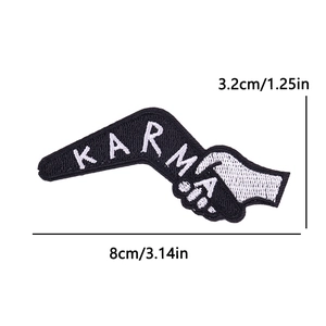 Detail view of Karma embroidered patch with handshake design and precise white edge stitching