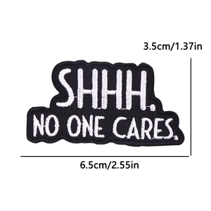 Embroidered iron-on patch SHHH NO ONE CARES letters in black and white 6.5x3.5cm