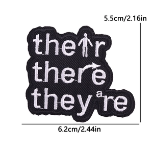 Cartoon black and white embroidered iron-on patch with grammar words their there they're