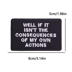 Close-up of rectangular black and white embroidered slogan patch with iron-on backing