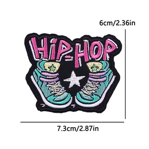 Detailed view of hip-hop embroidered patch with pink lettering and blue high-top sneakers