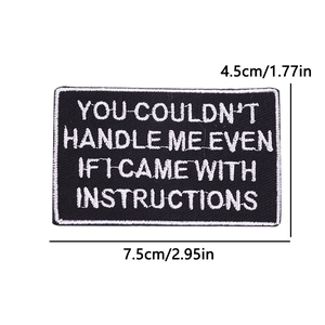 Detailed size view of black rectangular embroidered quote patch with iron-on backing