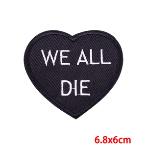 Detailed close-up of heart embroidered patch with WE ALL DIE text, size 6.8x6cm