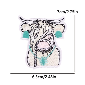 Detailed Highland cow embroidery patch showing 7cm height dimensions and black white fur