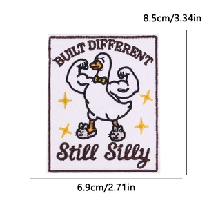 Close-up of muscular duck embroidery patch with Built Different text and measurements