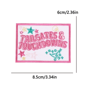 Detail view of pink Tailgates & Touchdowns embroidered patch, dimensions 8.5cm x 6cm
