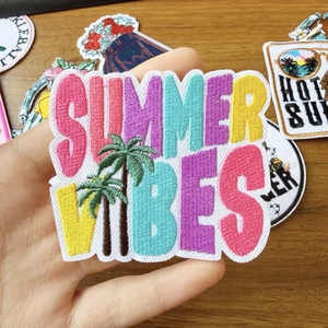 Summer Vibes beach surf embroidery patch with palm trees shown in hand for scale