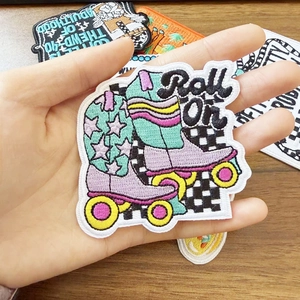 Retro Roll On embroidered roller skates patch featuring colorful stars and fine stitching
