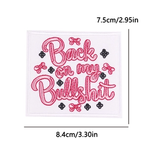 Detail of embroidered patch featuring pink Back on my Bullshit text with small bow