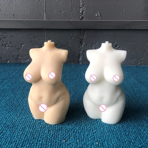 Detail of plus-size female body candle molds in white and nude silicone finish