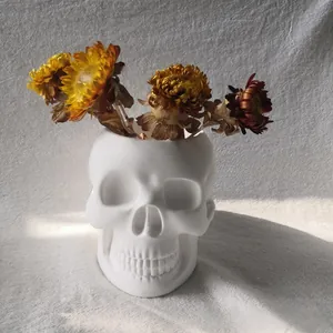 Macro detail of skull shaped planter mold for resin and concrete featuring dried flowers