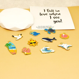 Detail view of colorful marine-themed alloy enamel charms including turtle and shell