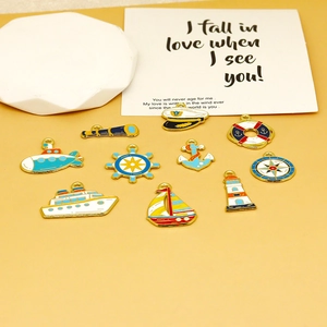 Detailed view of colorful enamel nautical charms including anchors and ships