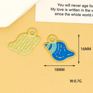 Detail view showing size and weight of blue enamel shell charm for DIY jewelry.