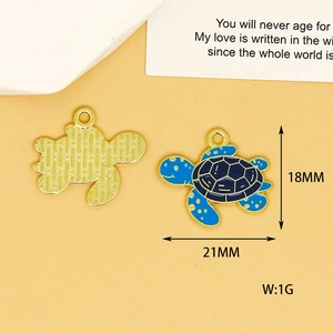Detail view of blue sea turtle enamel pendant with 18mm and 21mm size measurements