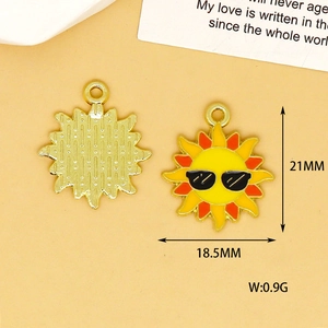 Detailed view of a yellow sun enamel pendant with sunglasses for DIY jewelry making