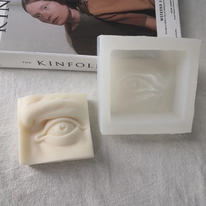 3D Silikonform in Augenform mit fertiger Skulpturkerze auf minimalistischem Hintergrund