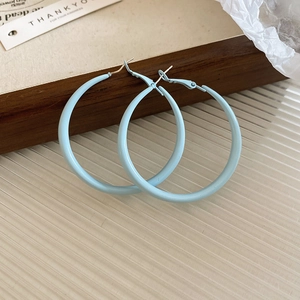 Detailed macro view of light blue enamel C-shaped hoop earrings with retro matte finish.