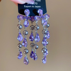Detailed macro view showing the brilliant sparkle of vintage purple crystal tassel earrings