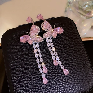 Detailed macro view of pink butterfly tassel earrings featuring sparkling cubic zirconia stones