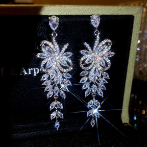 Detailed macro view of sparkling zircon tassel drop earrings with marquise-cut accents