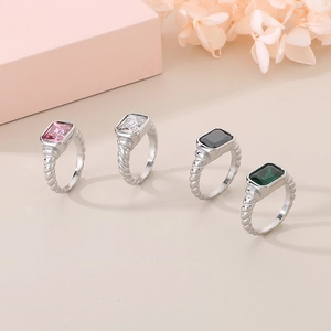 Set of four elegant square glass stone rings with twisted bands in various colors.