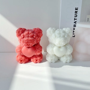 Close-up of pink and white rose bear candles with intricate 3D heart petal textures