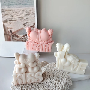 Romantic scented candles with heart and couple shapes on Love, Kiss and Heart bases