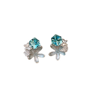 Elegant blue crystal butterfly flower stud earrings for women on white background