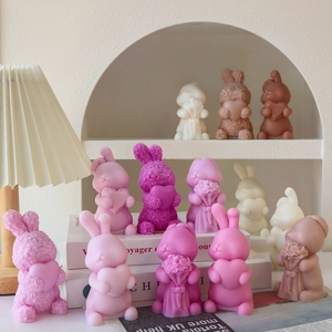 Detail of cute bunny scented candles with heart and rose textures for home decor