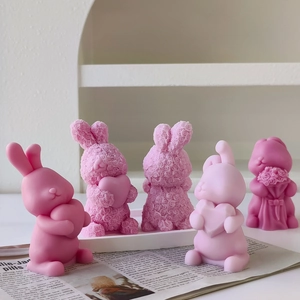 Detailed view of handmade bunny aroma candles in various pink shades and floral textures