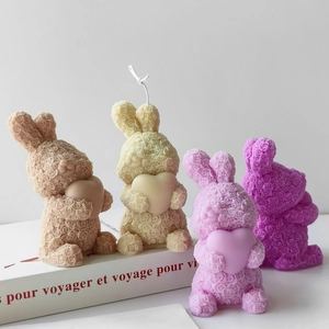 Detailed view of rabbit candles with rose textures in various colors for DIY decor