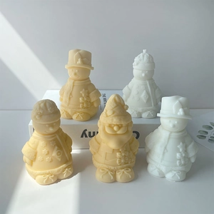 Close-up of snowman and Santa scented candles with intricate scarf and hat textures
