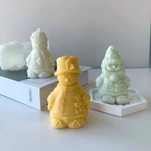 Detailed view of snowman and Santa shaped handmade candles with soft matte silicone texture