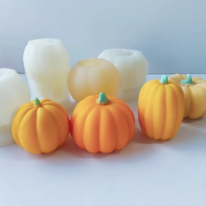 Detail view of various pumpkin silicone molds and finished orange craft resin candles