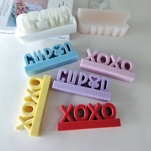 CUPID and XOXO silicone molds for DIY scented candles and soaps with various colors