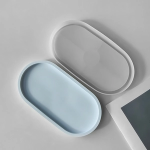 Detail of oval silicone mold and light blue plaster tray for DIY coaster making