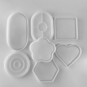 Detailed top view of various geometric silicone molds for resin casting and DIY coasters