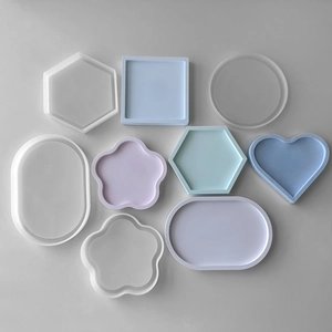 Macro view of various geometric silicone molds and colorful resin tray creations